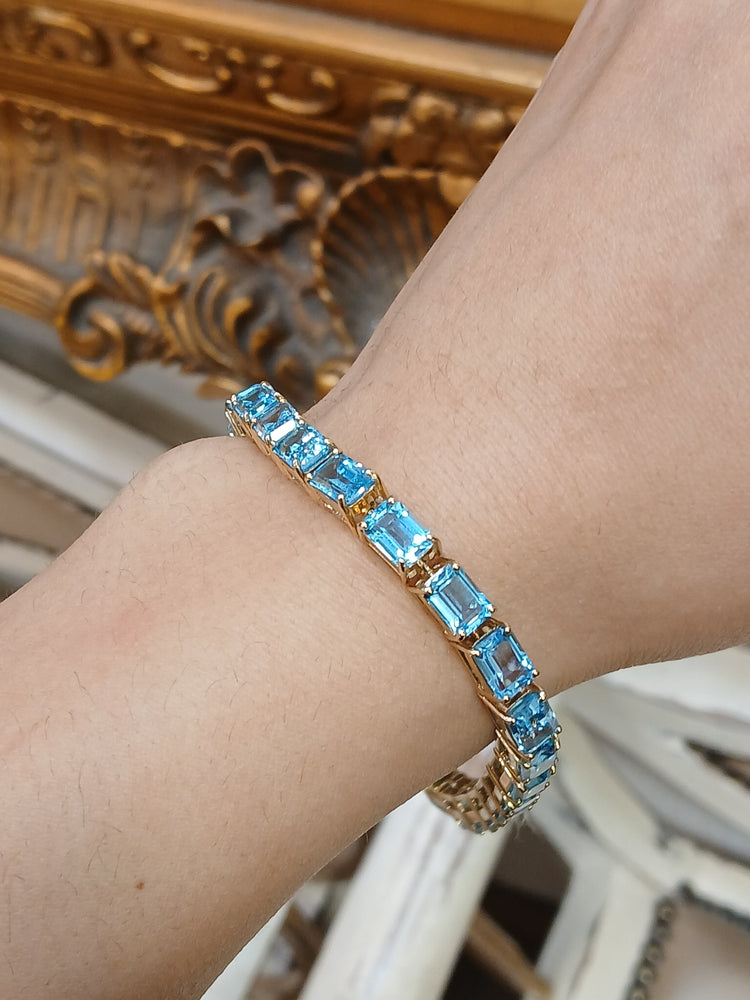 Women's 9ct Yellow Gold Tennis Bracelet with Emerald Cut Blue Topaz - Hyman’s Jewellers