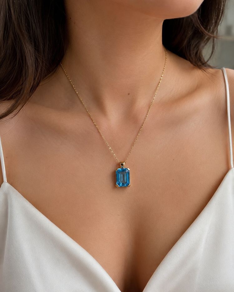 Emerald Cut Blue Topaz Solitaire Pendant in 9ct Yellow Gold 7.2g