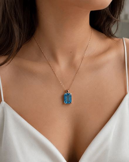 Emerald Cut Blue Topaz Solitaire Pendant in 9ct Yellow Gold 7.2g - Hyman’s Jewellers