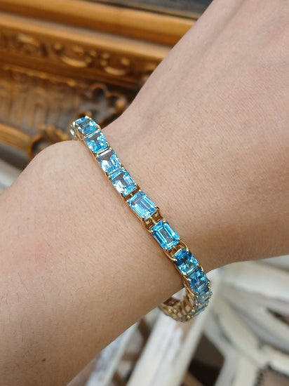Women's 9ct Yellow Gold Tennis Bracelet with Emerald Cut Blue Topaz - Hyman’s Jewellers