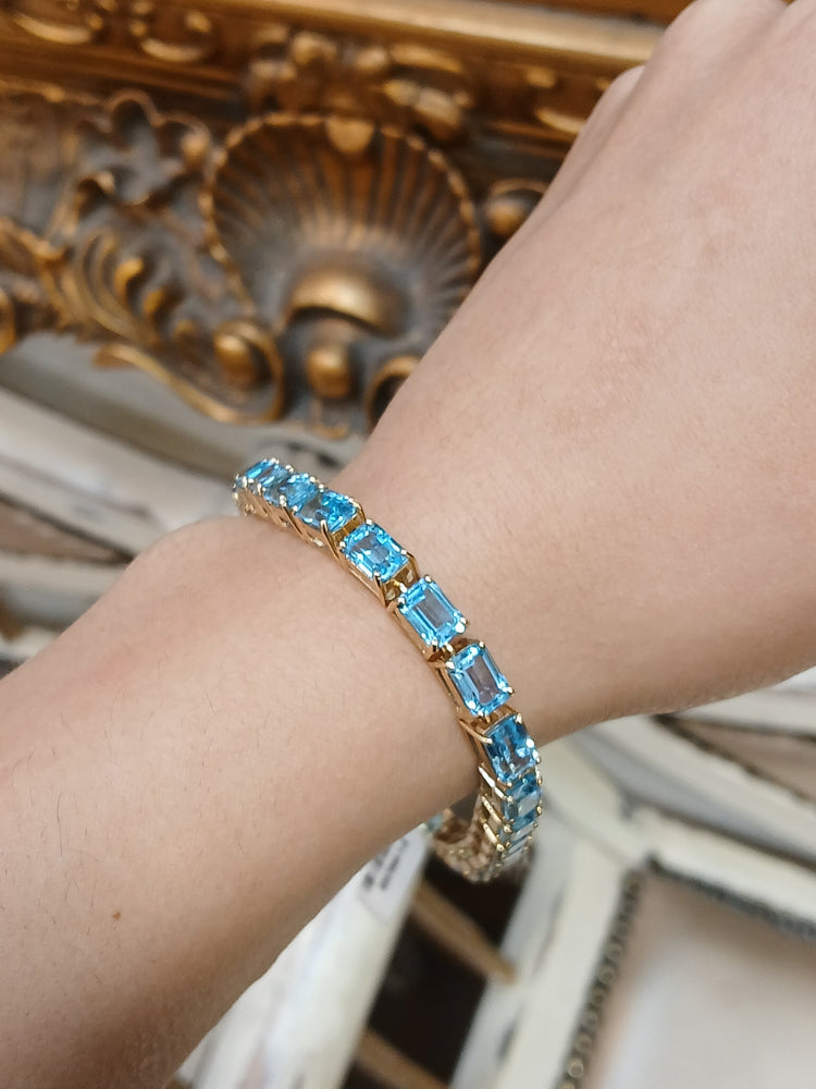 Women's 9ct Yellow Gold Tennis Bracelet with Emerald Cut Blue Topaz - Hyman’s Jewellers