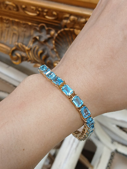 Women's 9ct Yellow Gold Tennis Bracelet with Emerald Cut Blue Topaz - Hyman’s Jewellers